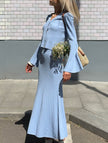Blue FJØRNA V-neck cardigan maxi dress, slim fit, elegant design, made for versatile wear, shown on a model against a plain background.