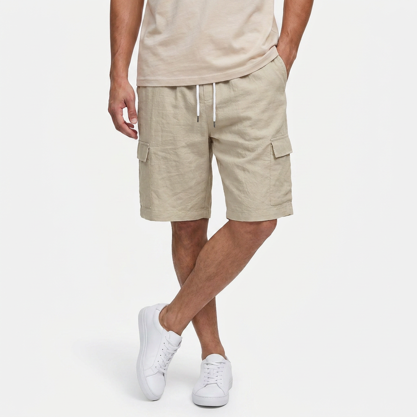 Men's beige linen cargo shorts with drawstring waist, casual fit, worn by a model in a relaxed pose.