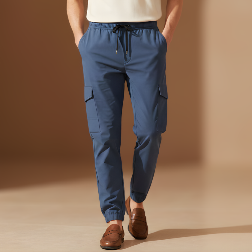 Blue men's cargo trousers by FJØRNA with drawstring waist, relaxed fit, and multiple pockets, ideal for casual wear.