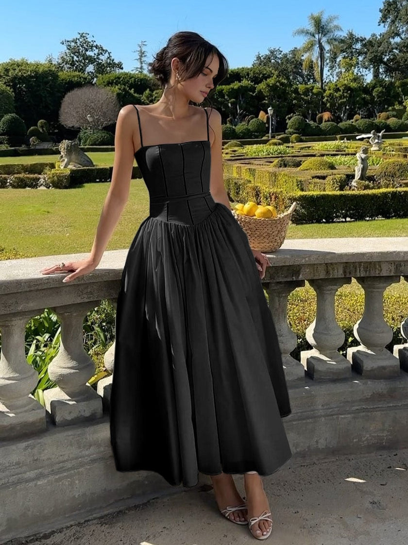 FJØRNA strapless satin corset midi dress with a full skirt, sleeveless and fitted, perfect for elegant wedding guest attire.