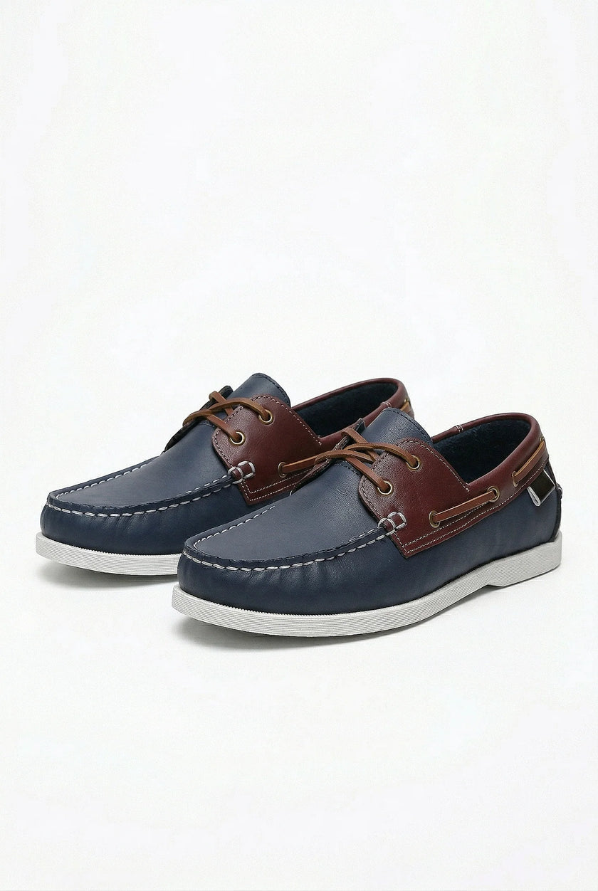 Men's boat shoes by FJØRNA with PU upper, nautical styling, and casual design, shown in a refined spring-ready look.
