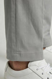Men's FJØRNA straight chino trousers, smart structured business pants with tailored fit, shown in a stylish executive setting.