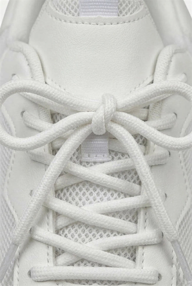 White mesh trainers for women by FJØRNA, breathable lightweight casual shoes with cushioned soles and sporty design.