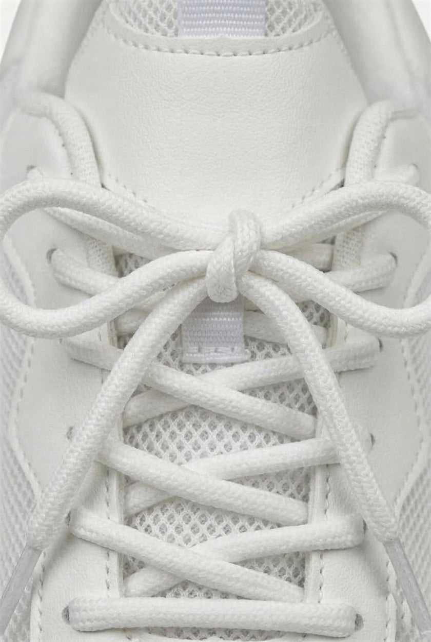 White mesh trainers for women by FJØRNA, breathable lightweight casual shoes with cushioned soles and sporty design.
