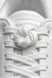 White minimalist casual trainers for women by FJØRNA, featuring a classic, timeless design with clean lines and comfortable fit.