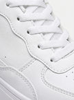 FJØRNA white minimalist men's trainers, clean everyday shoes with a sleek design and comfortable fit, shown from the side.