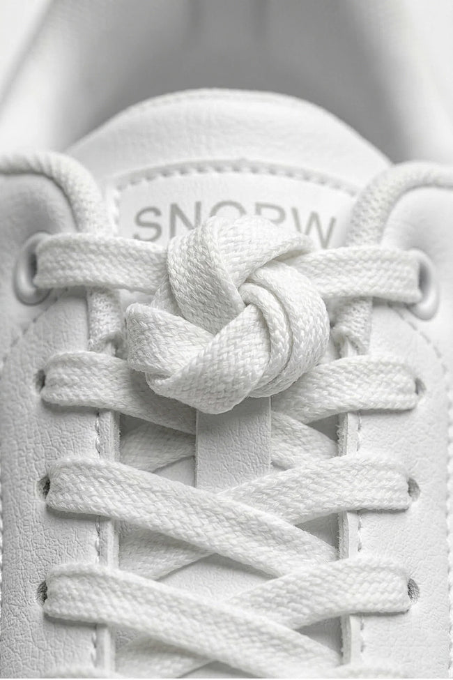 White minimalist casual trainers for women by FJØRNA, featuring a classic, timeless design with clean lines and comfortable fit.