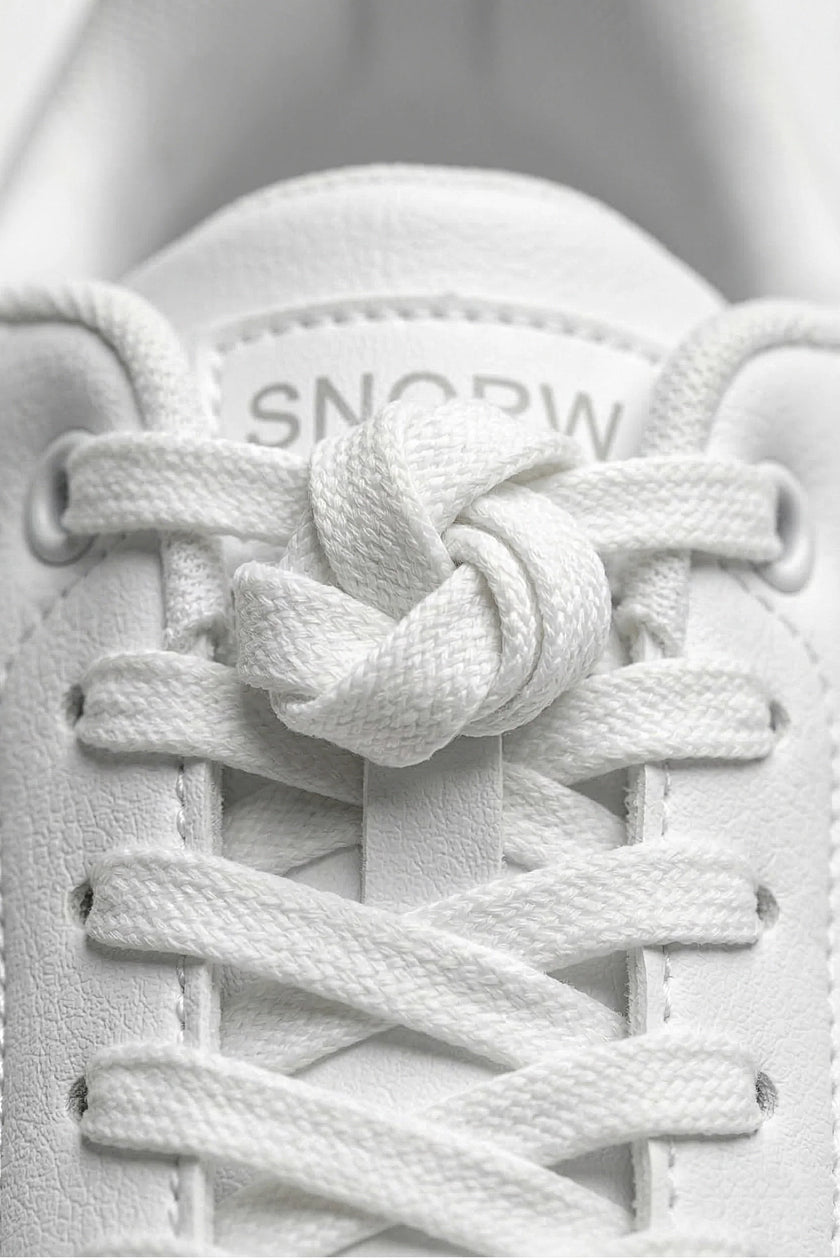 White minimalist casual trainers for women by FJØRNA, featuring a classic, timeless design with clean lines and comfortable fit.