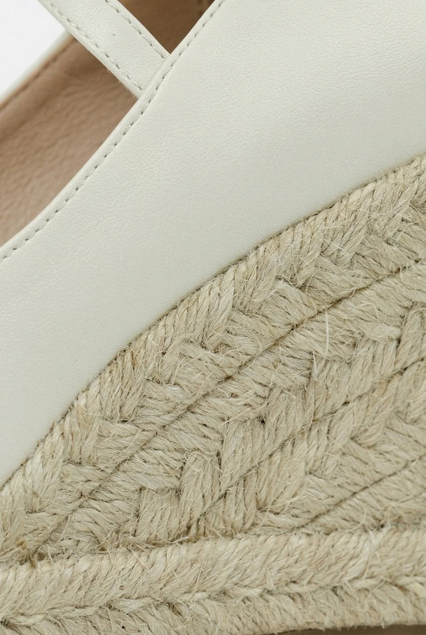 FJØRNA women's ankle-strap wedge sandals with espadrille platform and elegant design, shown from a front angle.
