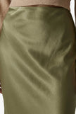 Women’s high-waist midi satin skirt by FJØRNA, flowing and elegant, showcased in a stylish fashion shot.