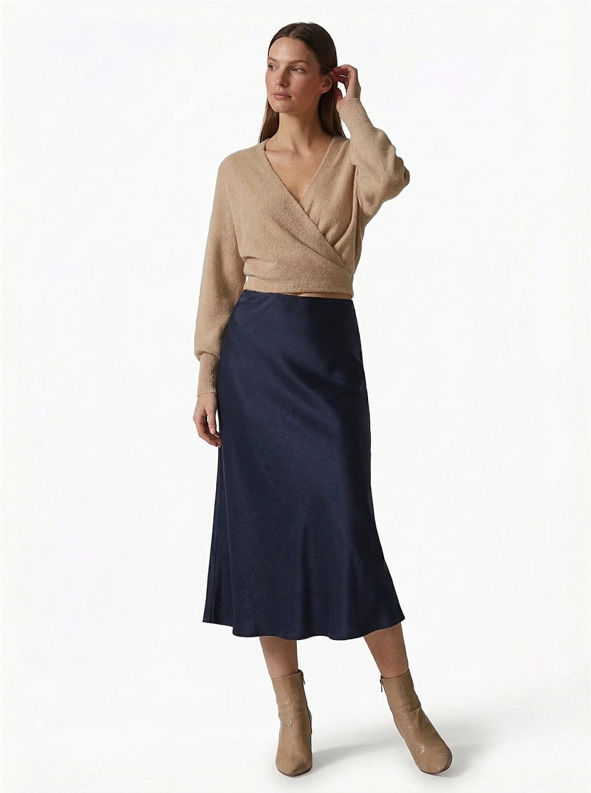 Elegant FJØRNA high-waist satin midi skirt for women, flowing and stylish with a sophisticated silhouette.