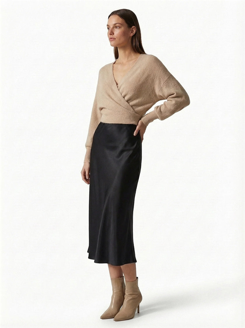 Elegant high-waist satin midi skirt for women by FJØRNA, flowing and stylish, shown in a natural pose.