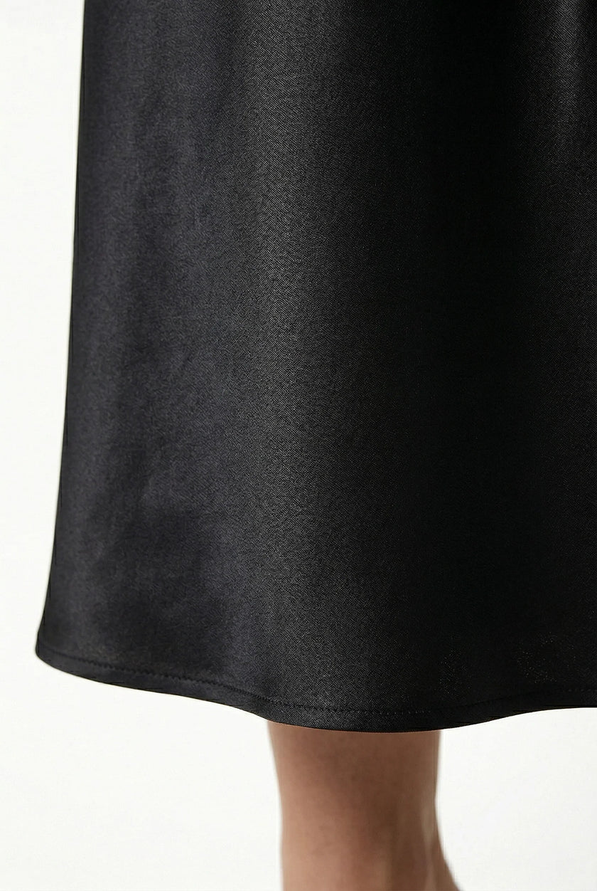 Elegant FJØRNA women's high-waist midi satin skirt with flowing design, showcasing its smooth fabric and stylish silhouette.