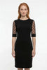 Black FJØRNA midi dress for women featuring an A-line silhouette with lace sleeves and contrasting fabric details.