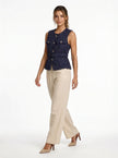 FJØRNA women's tailored sleeveless waistcoat with structured design, layered over a minimalist outfit, shown with pointed-toe heels.