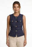 FJØRNA women's tailored sleeveless waistcoat with structured fit, layered over outfit, shown with minimalist pointed-toe heels.