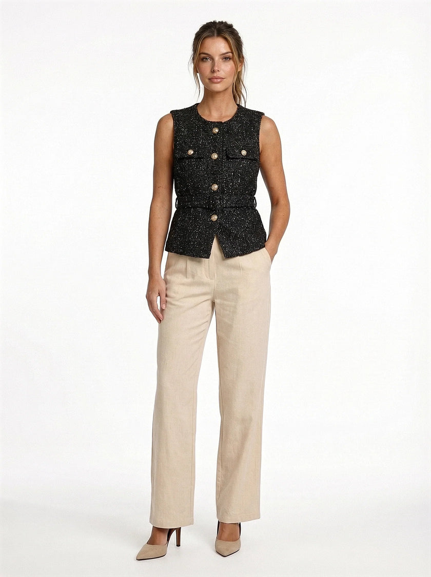 FJØRNA women's tailored sleeveless waistcoat with structured design, layered over a blouse, shown with minimalist pointed-toe heels.