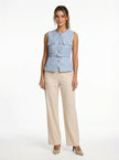FJØRNA women's tailored sleeveless waistcoat with structured design, layered over a minimalist outfit, paired with pointed-toe heels.
