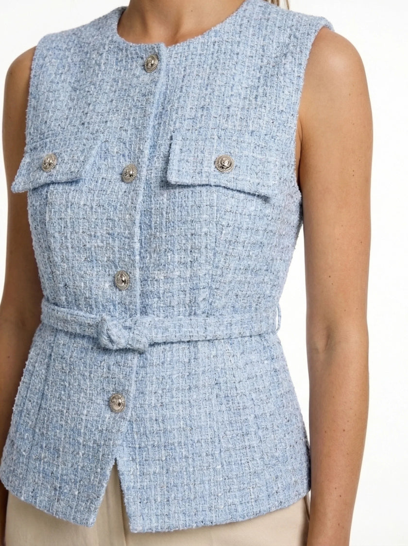FJØRNA women's tailored sleeveless waistcoat with structured design, layered over a minimalist outfit, paired with pointed-toe heels.