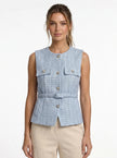 FJØRNA women's tailored sleeveless waistcoat with structured design, shown layered over a minimalist outfit, pointed-toe heels.