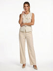 FJØRNA women's tailored sleeveless waistcoat with structured fit, layered over a outfit, styled with minimalist pointed-toe heels.