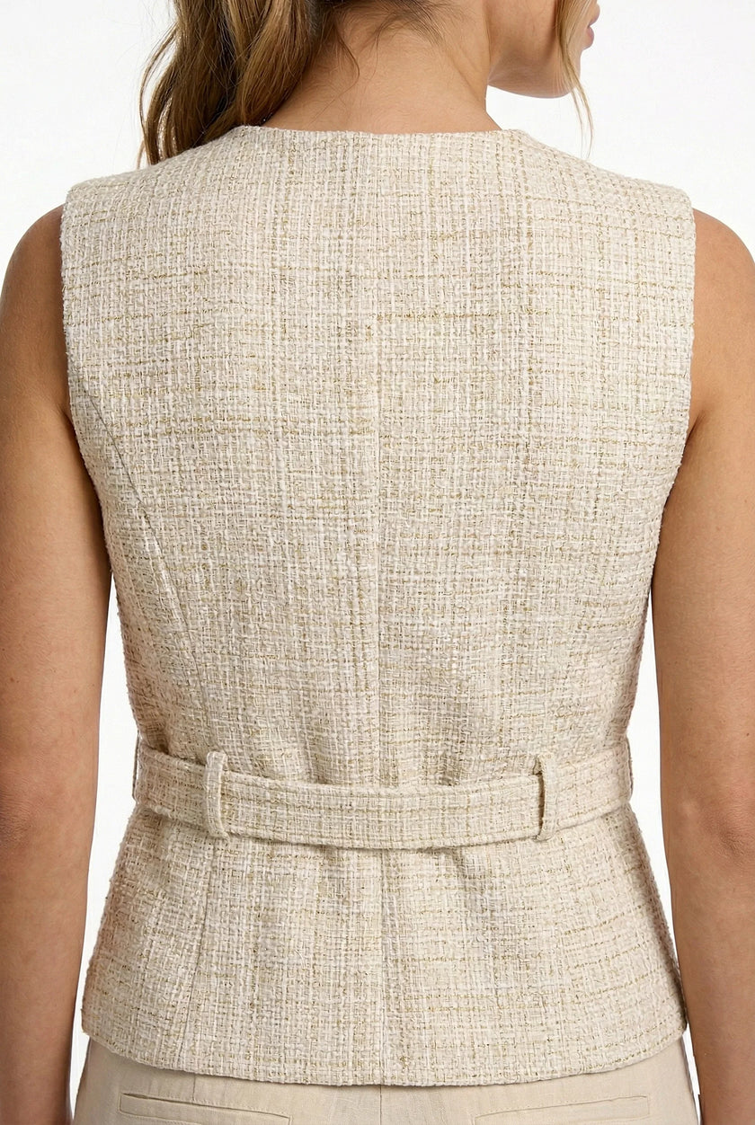 Women's tailored waistcoat by FJØRNA, structured sleeveless layering piece with minimalist design, shown with pointed-toe heels.