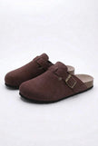 FJØRNA women's slip-on suede clogs, spring casual shoes with a comfortable and refined design, shown in a natural outdoor setting.