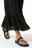 Black FJØRNA midi dress for women, sleeveless and flowing, perfect for elegant everyday wear, shown in a close-up image.