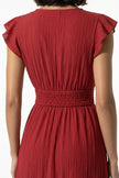 FJØRNA flowing sleeveless midi dress in brick red, featuring elegant, lightweight fabric perfect for everyday wear.