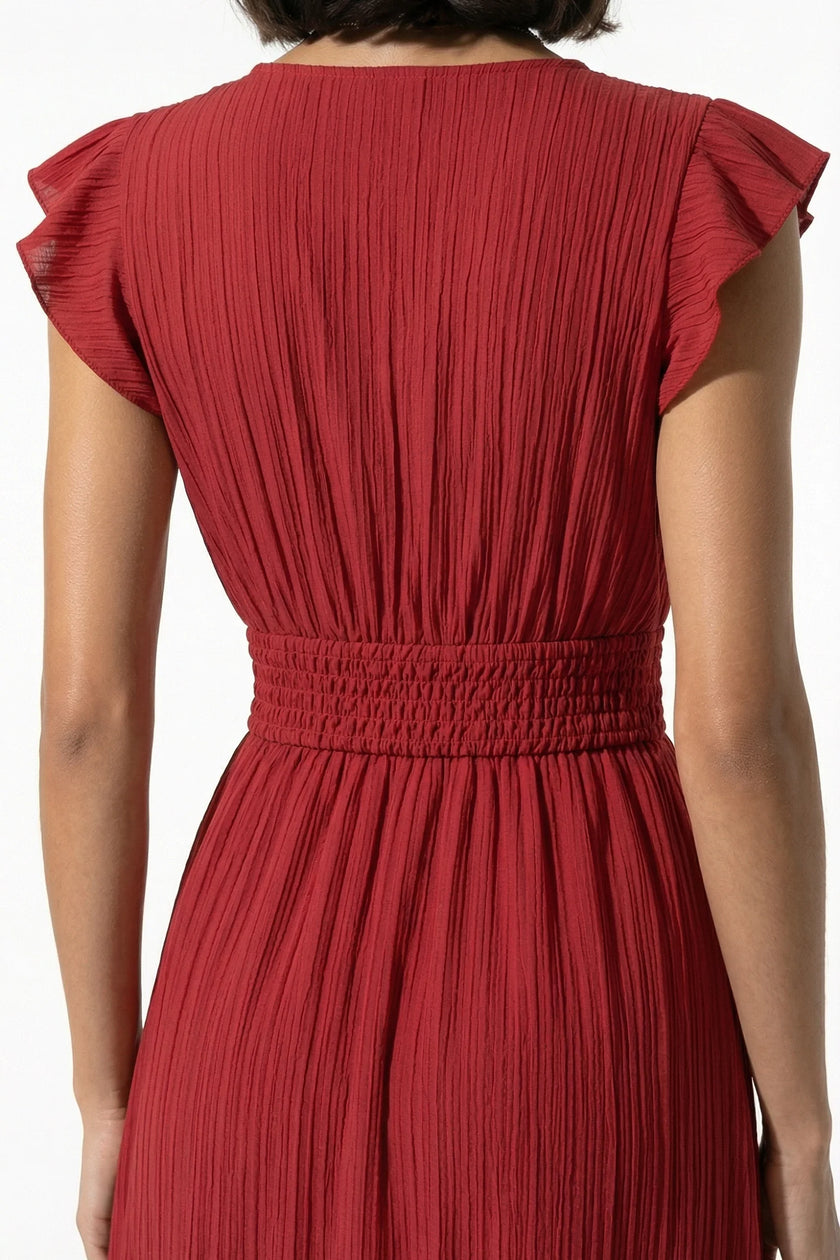FJØRNA flowing sleeveless midi dress in brick red, featuring elegant, lightweight fabric perfect for everyday wear.