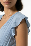 Sky blue FJØRNA midi dress for women, sleeveless and flowing, perfect for everyday elegant wear.
