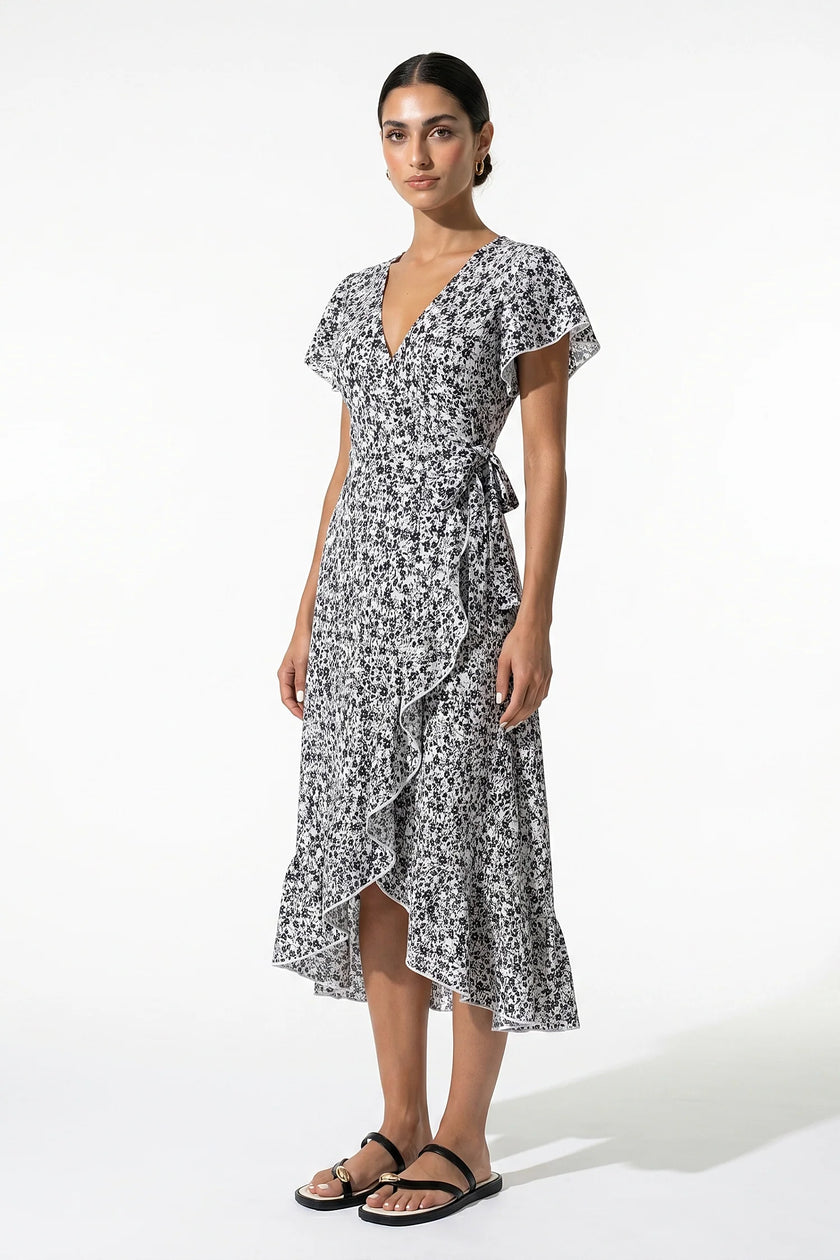 Black and white floral midi dress for women by FJØRNA, featuring an A-line casual summer style, shown on a full-body mannequin.