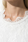 White floral lace maxi dress by FJØRNA featuring pleated A-line design, perfect for summer occasions.