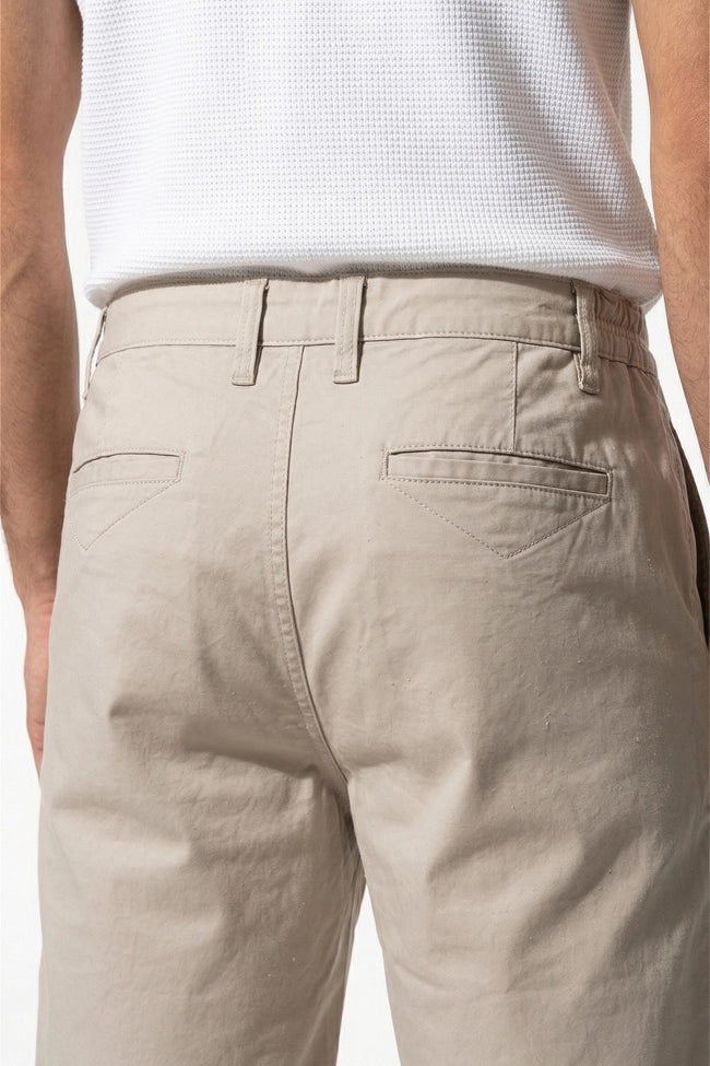Men's cotton chino shorts by FJØRNA in champagne, tailored summer casual pants with a clean, relaxed fit and smooth fabric.