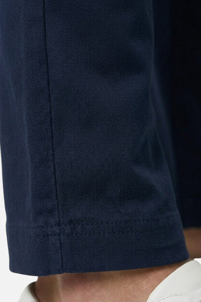 Men's straight fit stretch chino trousers by FJØRNA, tailored casual pants with a smart, sleek design in a neutral color.