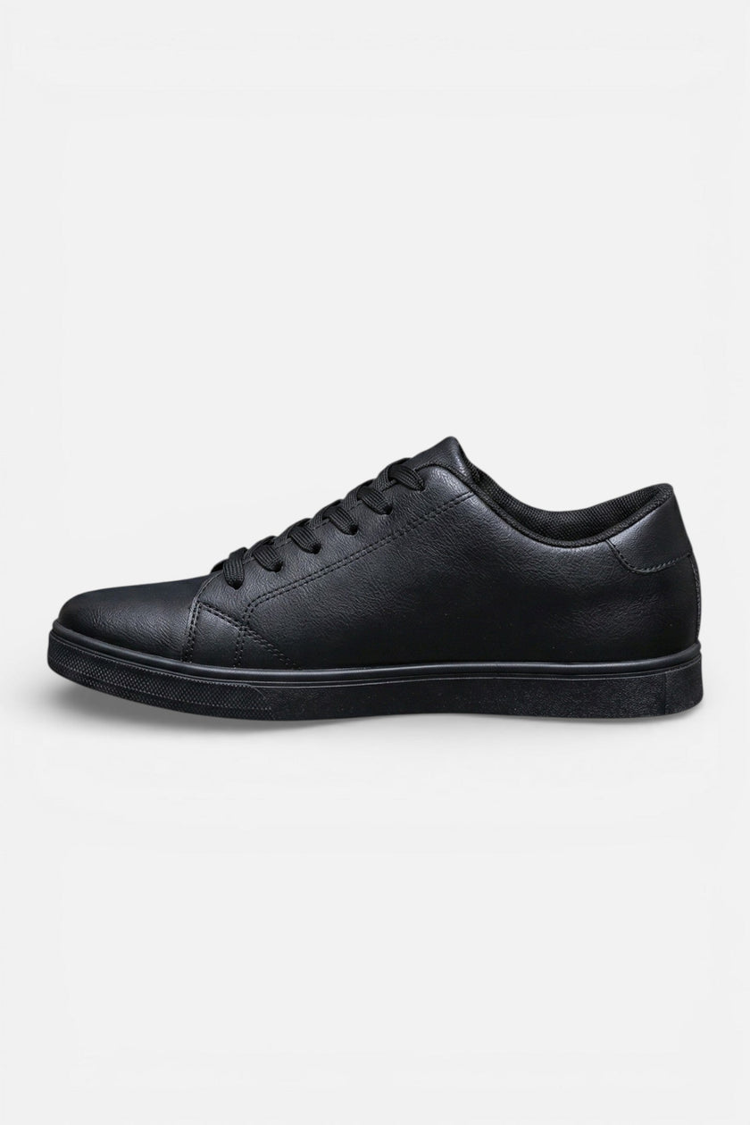Lightweight breathable men's casual trainers by FJØRNA, showcasing comfortable everyday shoe style in a natural outdoor setting.