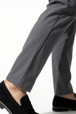 FJØRNA men's slim fit chino trousers in dark grey, ultra-thin stretch fabric, shown in a close-up macro image.