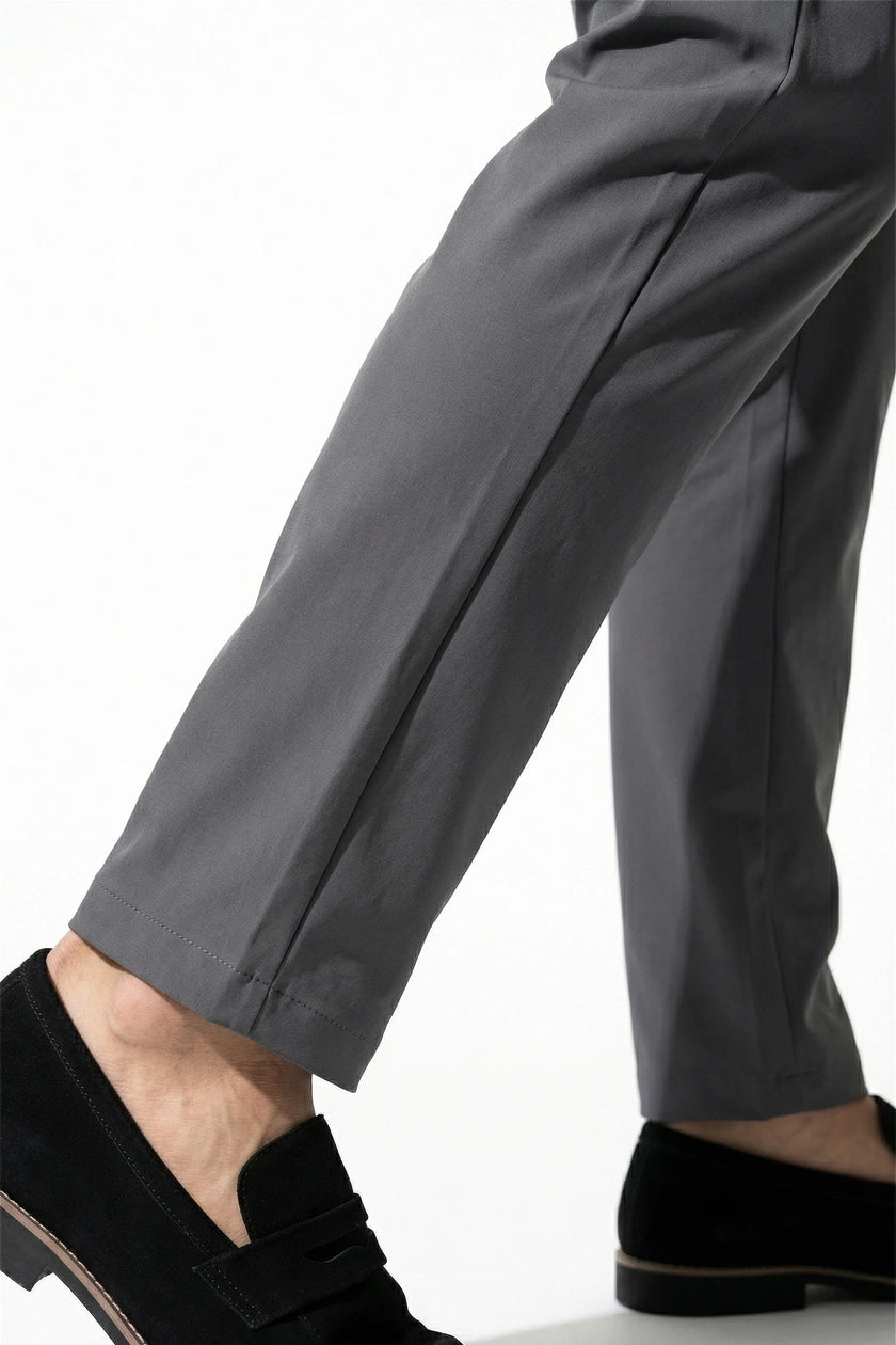 FJØRNA men's slim fit chino trousers in dark grey, ultra-thin stretch fabric, shown in a close-up macro image.