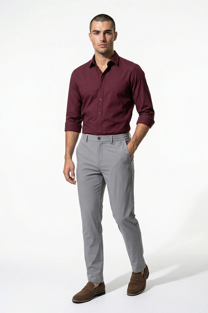 Men's slim fit chino trousers by FJØRNA, ultra-thin stretch fabric in light grey, full-body view showing tailored design.