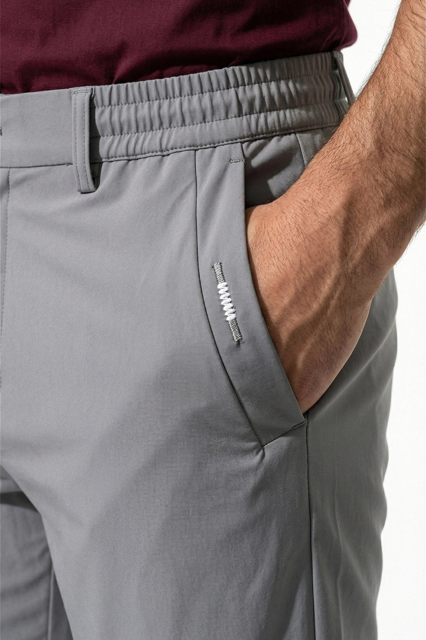 Light grey men's slim fit chino trousers by FJØRNA, ultra-thin stretch fabric, casual pants with a sleek, modern style.