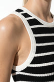 Black FJØRNA ribbed midi dress for women, slim fit, sleeveless, casual style, shown close-up of fabric texture.