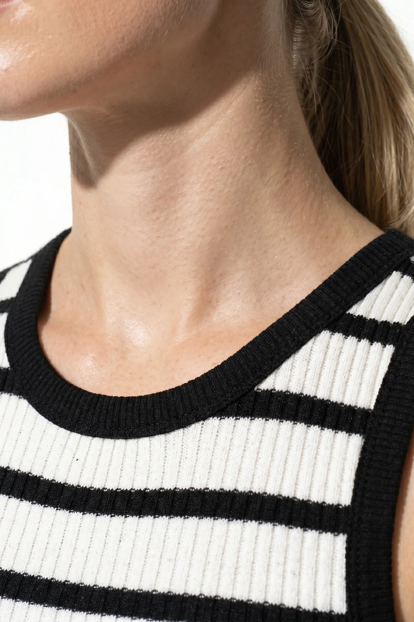 White ribbed midi dress by FJØRNA, sleeveless and slim fit, ideal for casual wear and stylish summer looks.