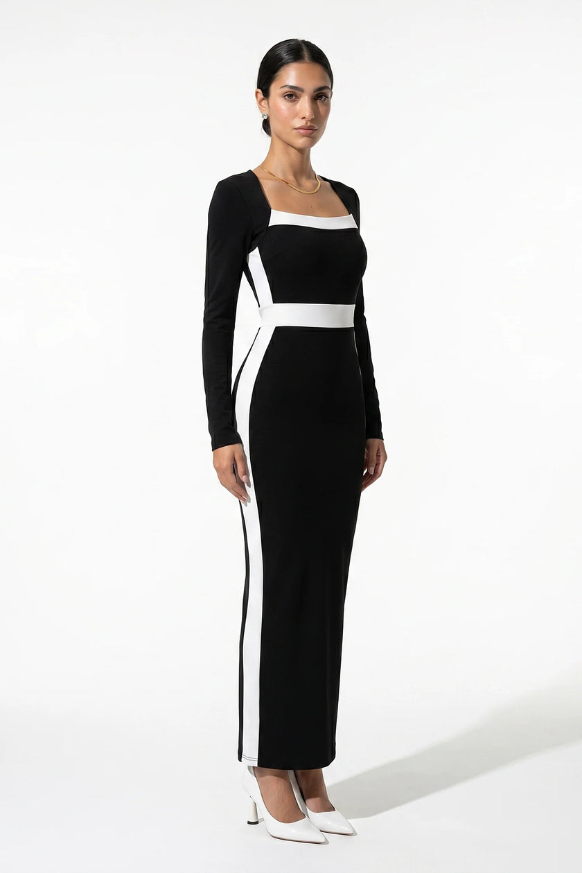 Black and white monochrome bodycon maxi dress for women by FJØRNA, shown from a 3/4 view highlighting fitted silhouette and stylish design.
