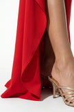 Red high-slit maxi dress for women with sling design and sleeveless style by FJØRNA, shown in a close-up image.