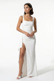 White high-slit maxi dress for women with a sling design, sleeveless style, by FJØRNA, full-length view showing elegant flow.