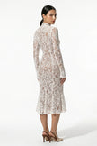Back view of FJØRNA women's white lace midi dress with long sleeves and fitted silhouette.