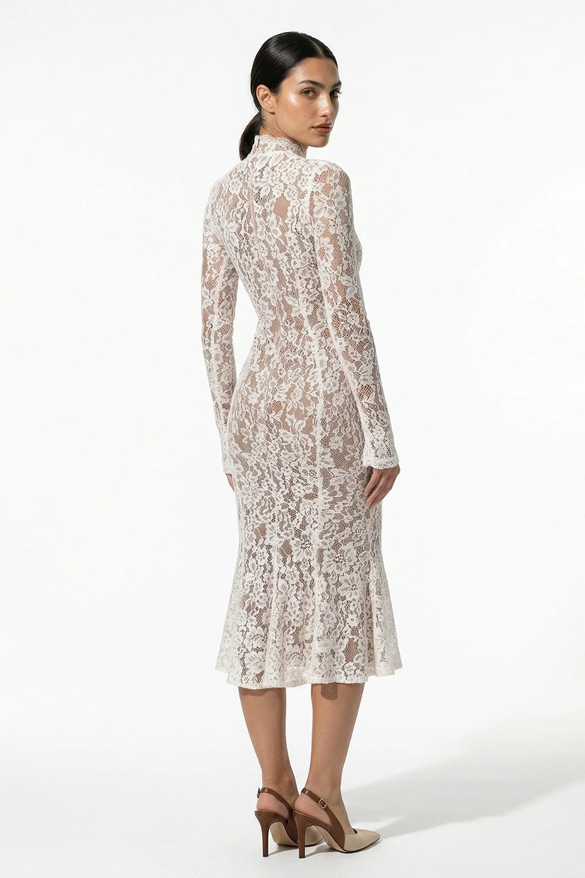 Back view of FJØRNA women's white lace midi dress with long sleeves and fitted silhouette.