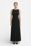 Flowing sleeveless women's maxi dress by FJØRNA, perfect for casual summer wear, shown in a coastal-inspired style.
