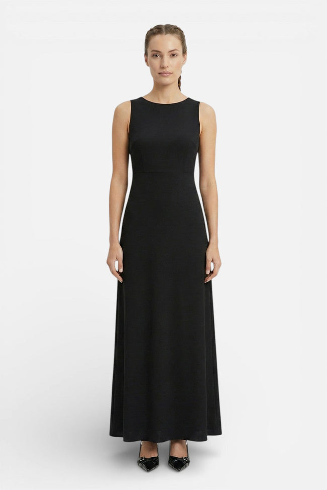 Flowing sleeveless women's maxi dress by FJØRNA, perfect for casual summer wear, shown in a coastal-inspired style.