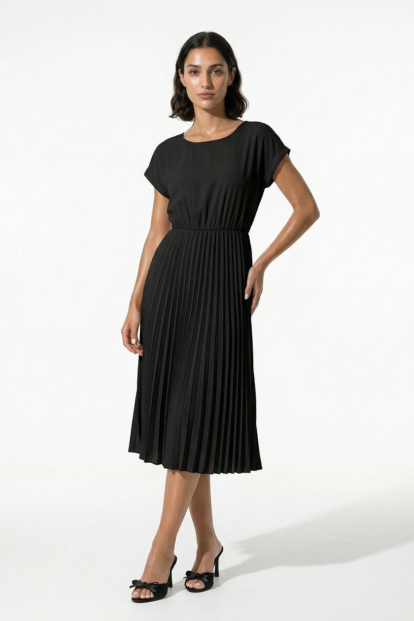 Black FJØRNA women's pleated midi dress with an A-line silhouette and round neckline, full-body view showing casual style.